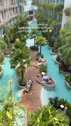 an aerial view of the pool and surrounding resort buildings with people lounging on lounge chairs