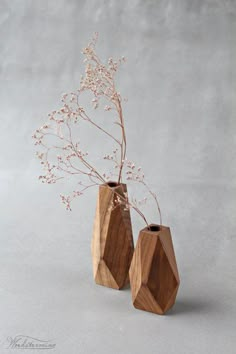 two wooden vases with flowers in them