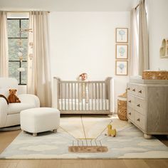 a baby's room with a crib, rocking chair and teddy bear in it