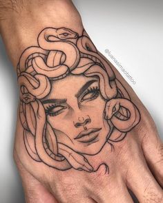 a woman's hand with a tattoo on it