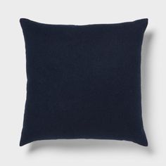 a dark blue pillow on a white background