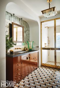 a bathroom with a sink, mirror and tiled flooring in it's center