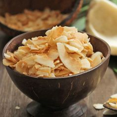 a wooden bowl filled with nuts on top of a table