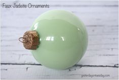 a green ball with a gold ring on it