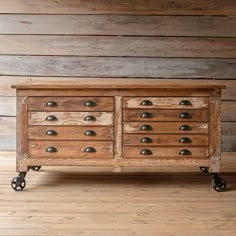 an old wooden dresser with metal knobs on wheels