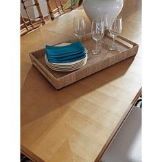 a wooden table topped with plates and glasses