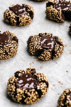 cookies with chocolate and sesame seeds on a baking sheet