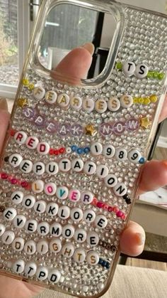 someone is holding up their phone case with the words spelled in different languages on it