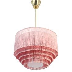 a pink and gold chandelier hanging from a ceiling fixture with pleated shades