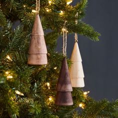 three wooden ornaments hanging from a christmas tree