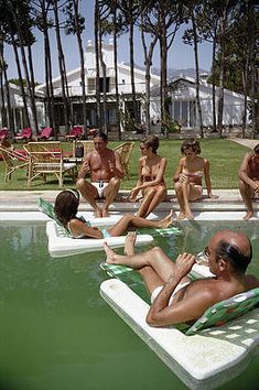 a group of people sitting around in the pool