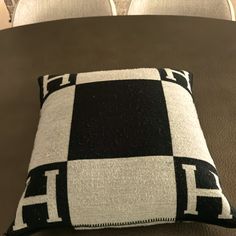 a black and white pillow sitting on top of a couch