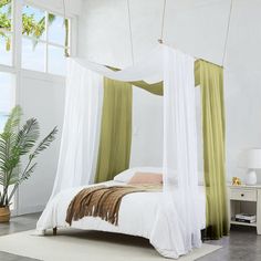 a bed with an orange and white canopy over it