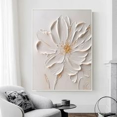 a living room with a chair and a large white flower on it's wall