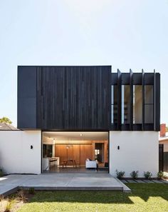 a modern house with black and white siding