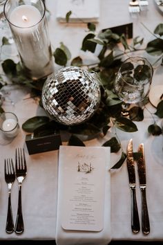 the table is set with silverware and place settings