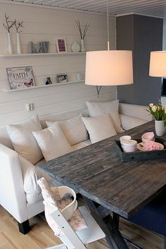 a living room filled with furniture and a wooden table