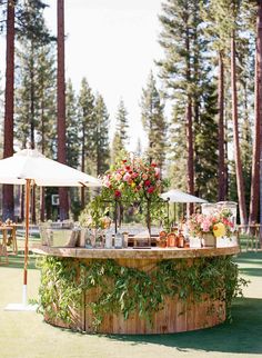 an outdoor bar with flowers and candles on it