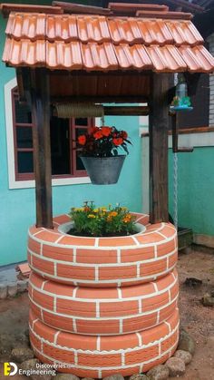 a potted plant sitting on top of a red brick wall next to a blue building