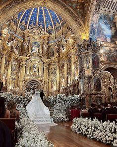 a wedding dress is displayed in the middle of a church