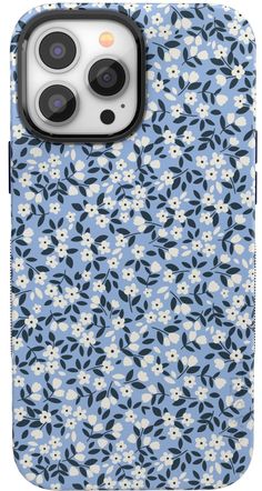 an iphone case with blue and white flowers on the front, and two black buttons in the back