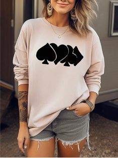 a woman wearing a sweatshirt that has three fish on it