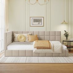 a large bed sitting in the middle of a room next to a window with curtains