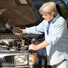 an older man working on his car engine