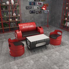 a living room with red and black furniture on the floor, bookshelves in the background