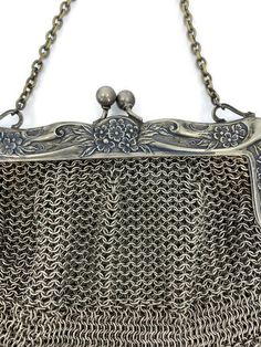 "A wonderful antique German silver purse, the Victorian metal mesh bag has a kiss closure on the hinged floral frame. Marked A B.M.CO Ger. Silver on the frame, the purse is a beautiful example of coin purses from the era The purse is in very good vintage condition. Overall a lovely antique bag and a great addition to your collection. The purse measures approximately 5 1/2\" tall by 5 1/2\" wide." Silver Metal Chainmail Bag, Elegant Silver Bag With Chainmail Detail, Elegant Silver Chainmail Bag, Vintage Handmade Silver Bag, Vintage Silver Handmade Bag, Handmade Victorian Style Silver Bags, Antique Silver Rectangular Evening Bag, Silver Antique Rectangular Evening Bag, Vintage Silver Rectangular Coin Purse