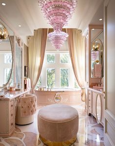 a pink chandelier hangs from the ceiling in a luxurious bathroom with vanity and stool