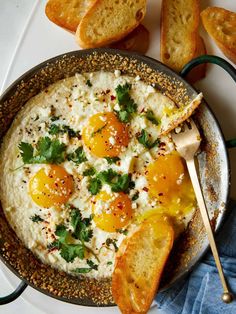 an egg dish with bread and parsley on the side is ready to be eaten