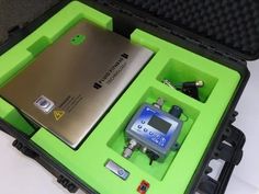 an electronic device in a green case on a table