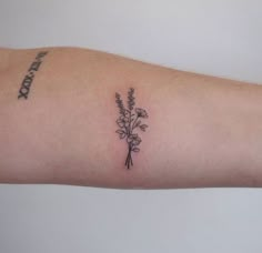 a small tattoo on the arm of a woman with flowers in it's center