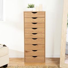 a tall wooden dresser sitting next to a window