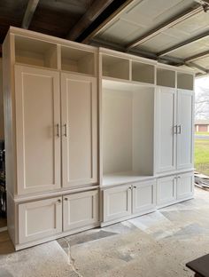 an empty room with white cabinets in it