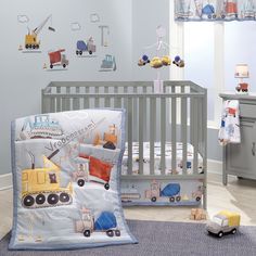 a baby crib bedding set with construction vehicles on it