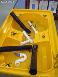 a yellow tray filled with different types of toothbrushes and other items in it