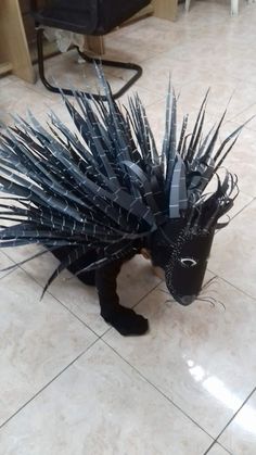 an animal with spikes on it's head standing in the middle of a floor