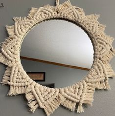 a round mirror hanging on the wall