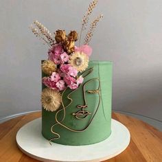 there is a green cake with flowers in it