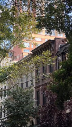 an apartment building is seen through the trees