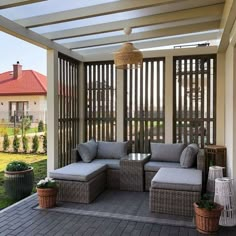 an outdoor living area with wicker furniture