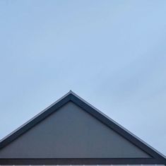 an airplane flying in the sky over a building