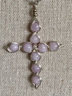 Wire wrapped cross pendant in either Iolite or Kunzite. Comes with 18' chain.Any metals used in jewelry are all nickel free, tarnish resistant (except for copper, which will change color(patina) over time). Metals are either bare copper, silvertone, or goldtone, unless otherwise stated.CRYSTAL DISCLAIMERAs crystals and stones come from the Earth, it is normal to find holes, cracks or other natural imperfections. Each one is unique and will vary from stone to stone. Please rest assured that each Cross Wire Jewelry, Wire Crafts Easy, Wire Wrapped Jewelry Beginner, Cross Jewelry Diy, Easy Wire Wrapping Stones, Wire Jewelry Diy Tutorial, Wire Wrapped Cross, Jewelry Tutorials Free, Wire Crosses