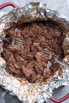 the food is being prepared and ready to be eaten in the pot with tongs