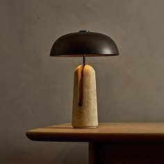 a table lamp sitting on top of a wooden table