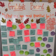 a bulletin board with notes and leaves on it