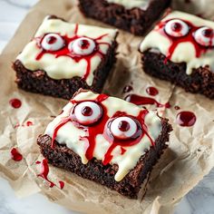 four brownies with googly eyes and white icing