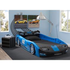 a blue race car themed bed in a child's bedroom